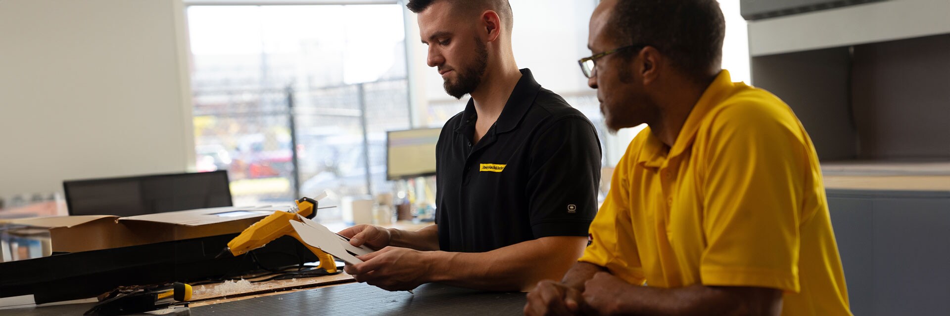 Two Stanley Black & Decker employees working on packaging prototype